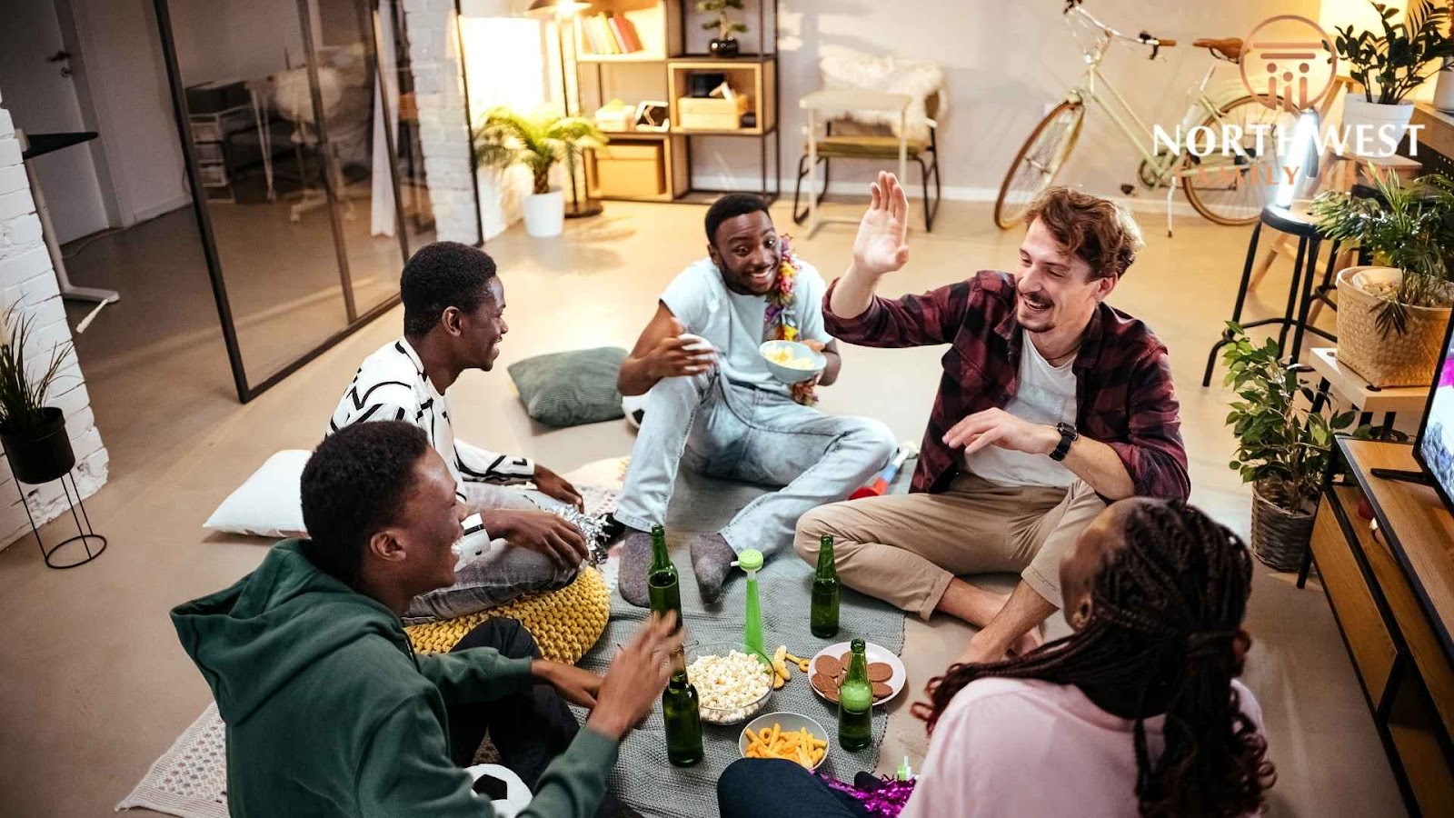 Friends enjoying snacks and conversation in cozy living room.