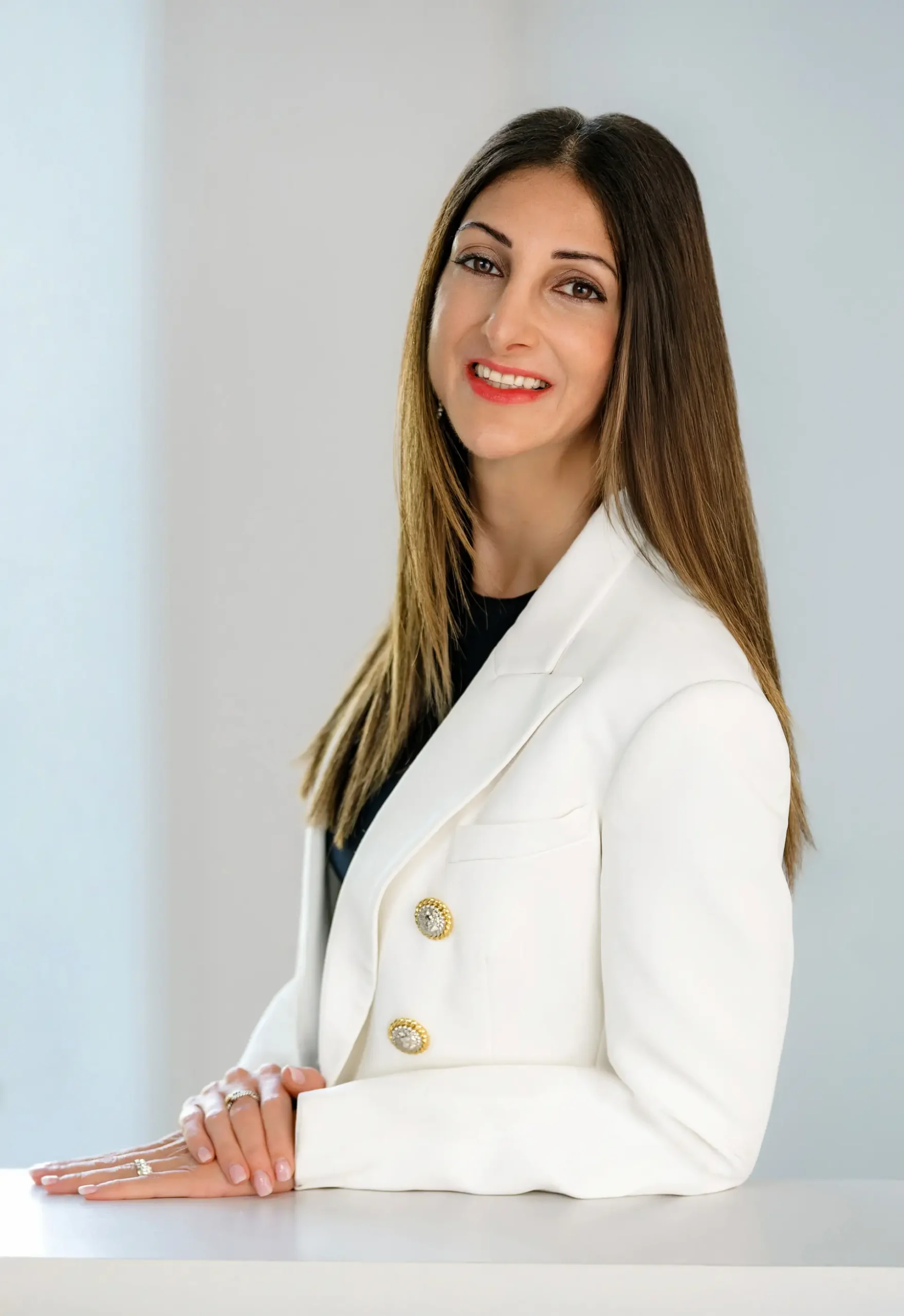 Smiling family law attorney in white blazer with long hair