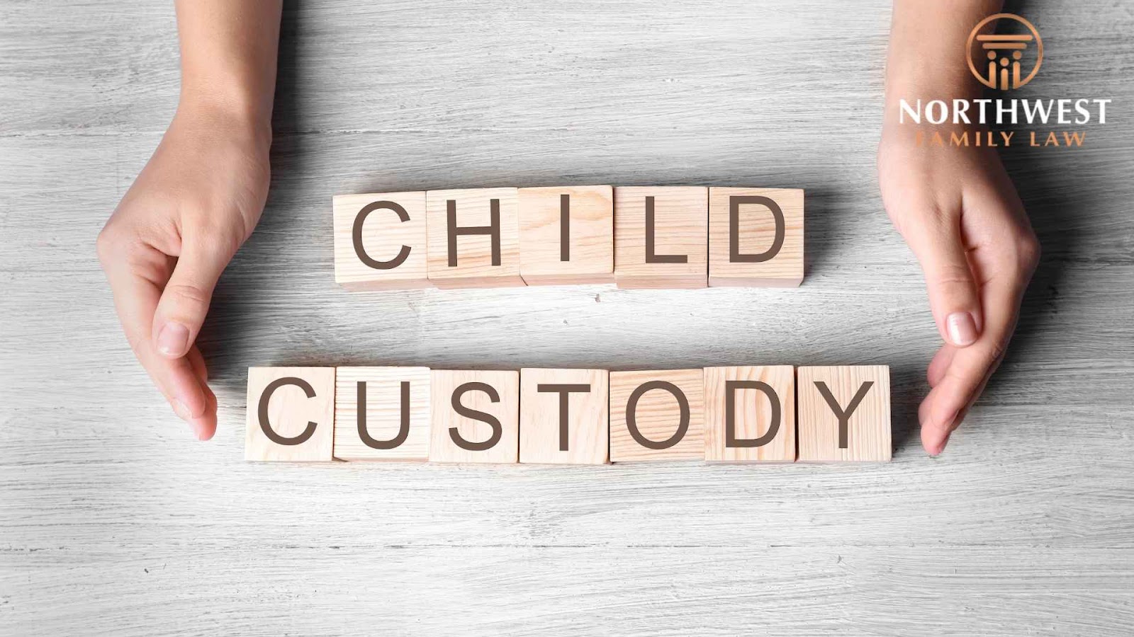 Hands protect blocks spelling child custody.