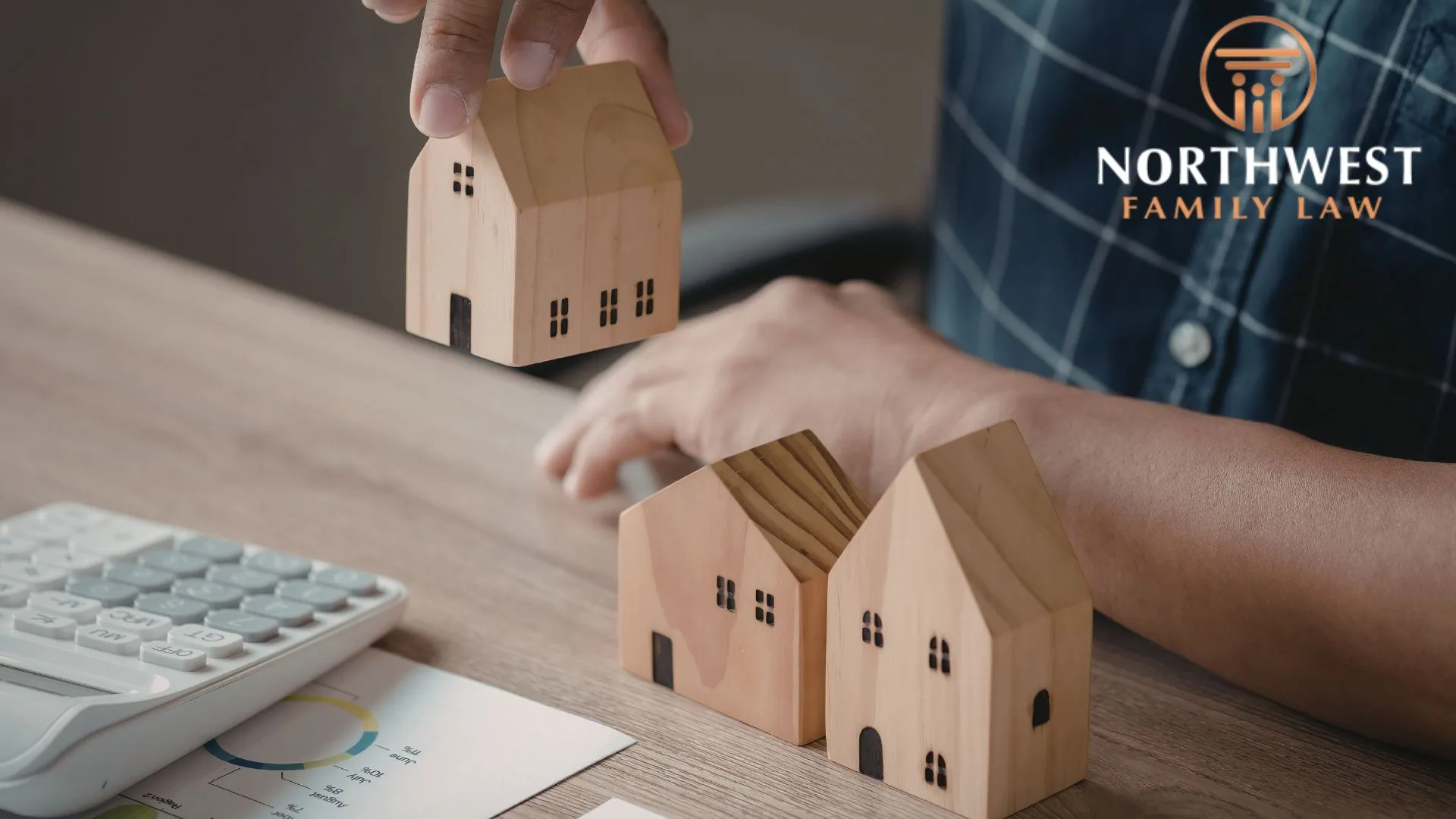 Person dividing toy house blocks, representing asset division in contested divorce in washington