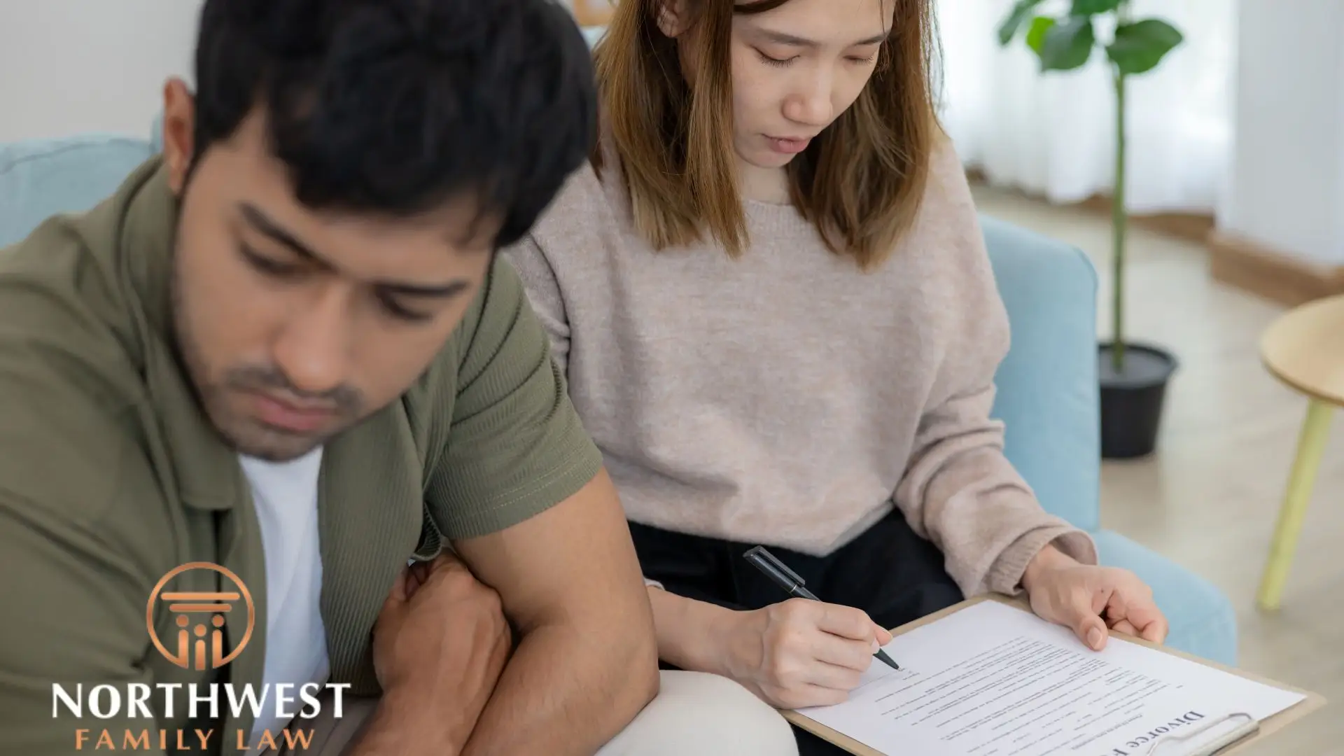 Couple reviewing divorce papers in living room.