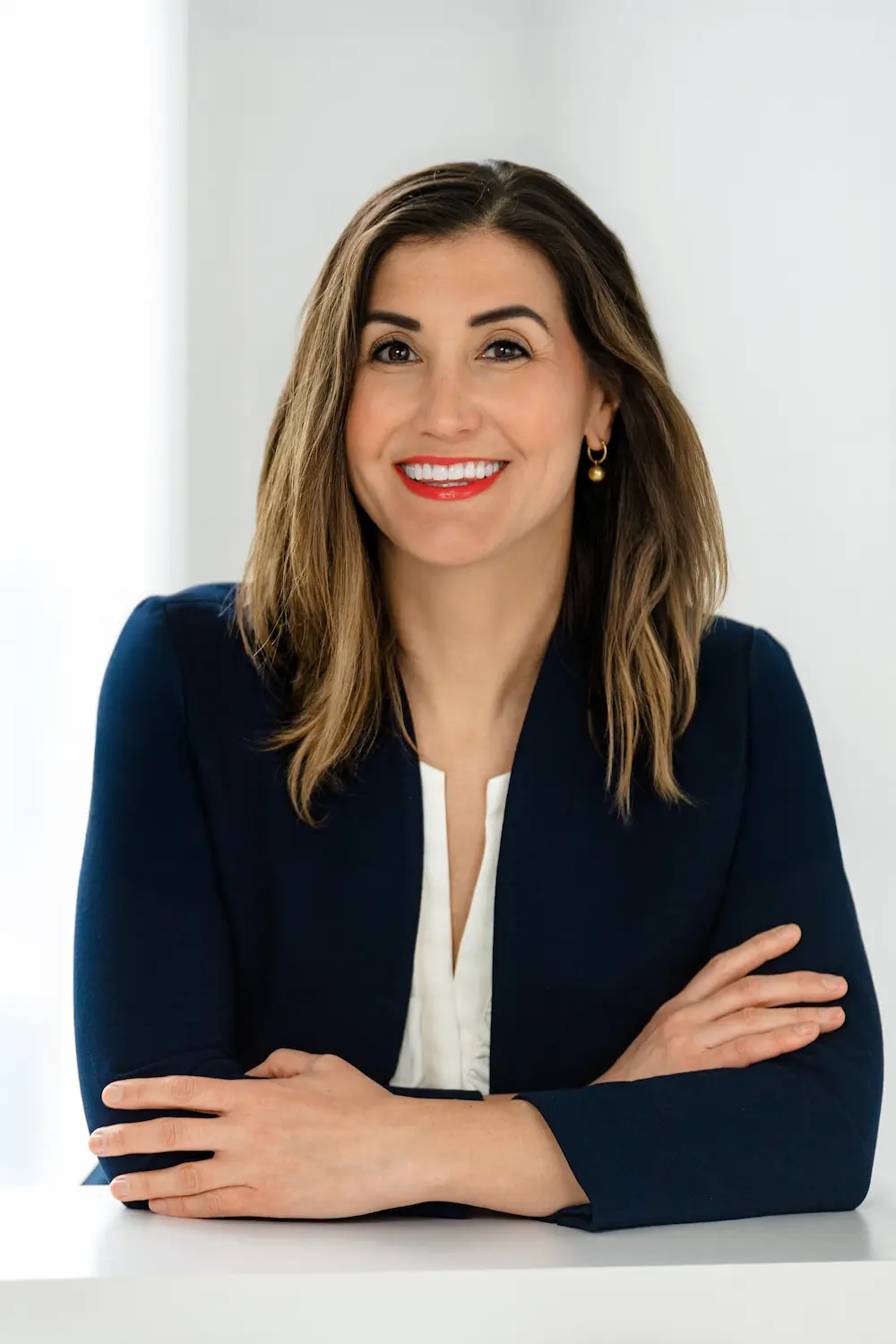 Smiling professional woman in navy blazer portrait